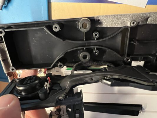 Inside view of the Reface CP's right speaker: plastic enclosure functioning as a bass reflex cabinet, opened. the speaker in a small front panel to the left, rubbery isolation and seal layer