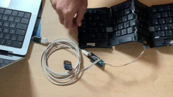 Unfolding a Stowaway keyboard connected to a computer via a Raspi Pico with a small display